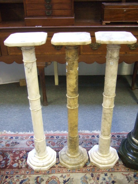 Appraisal: Three white vein marble turned columns or jardinare stands each