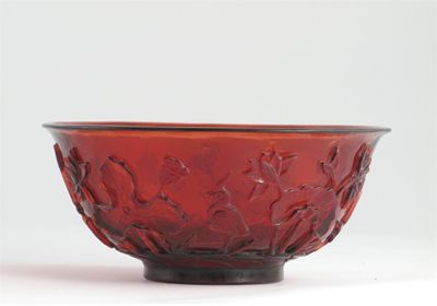 Appraisal: A Chinese Beijing red glass bowl carved in relief with