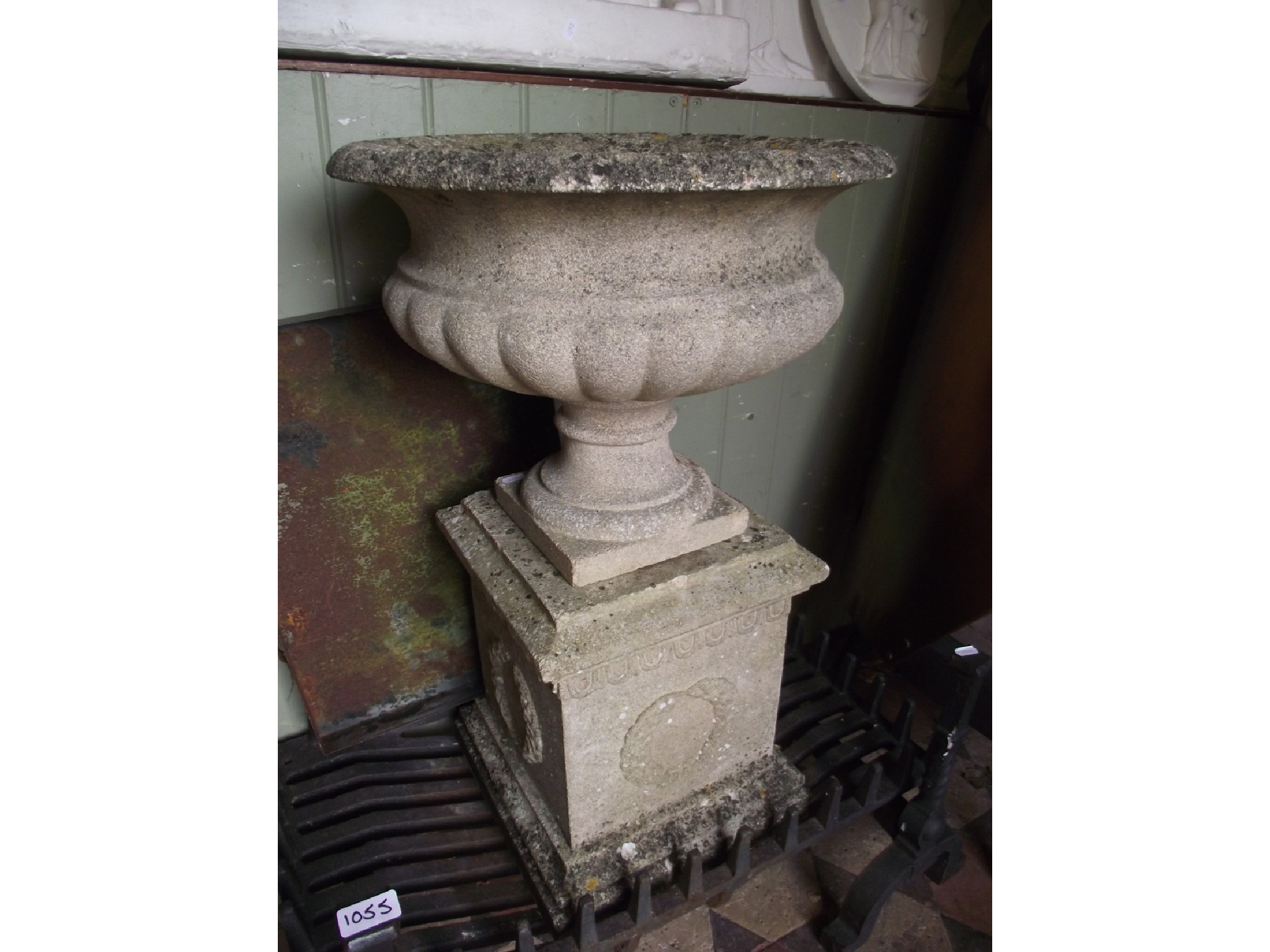 Appraisal: A weathered cast composition stone garden urn the squat circular