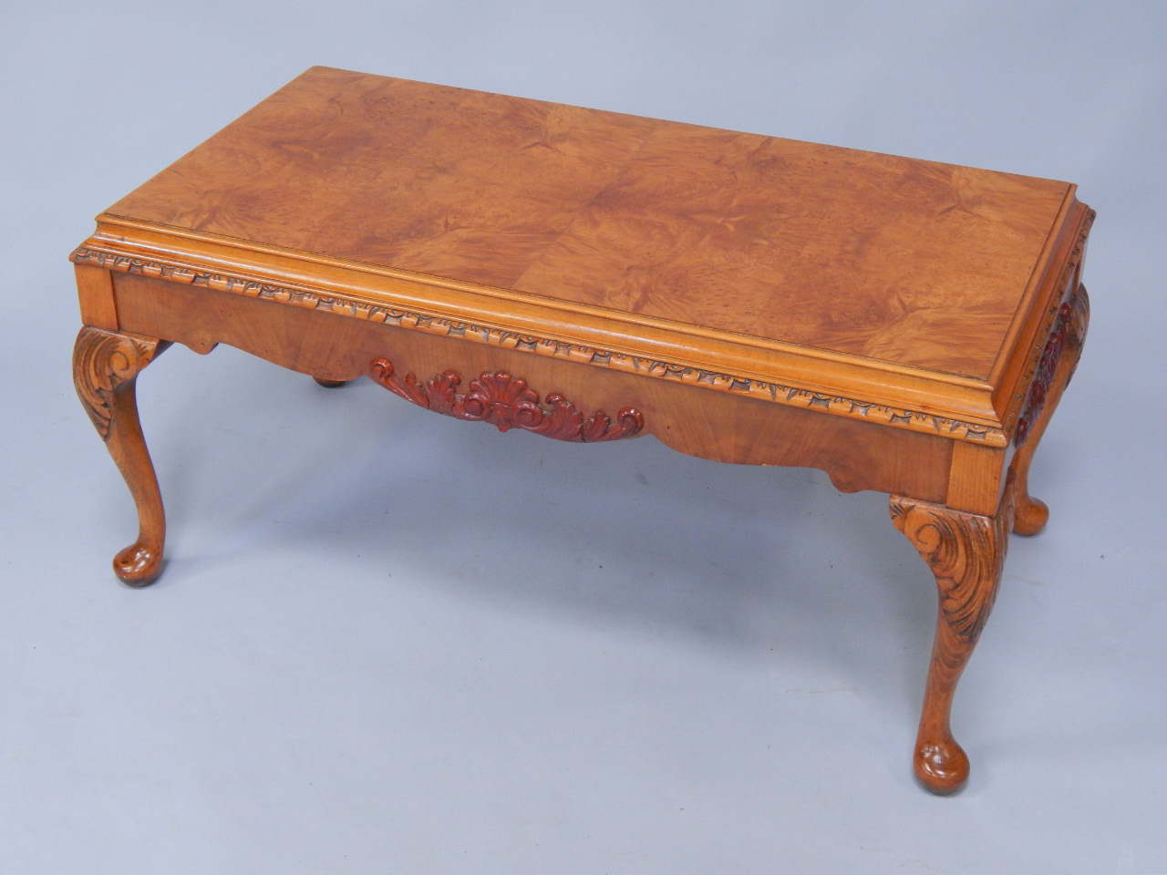 Appraisal: A walnut rectangular occasional table with a burr top carved