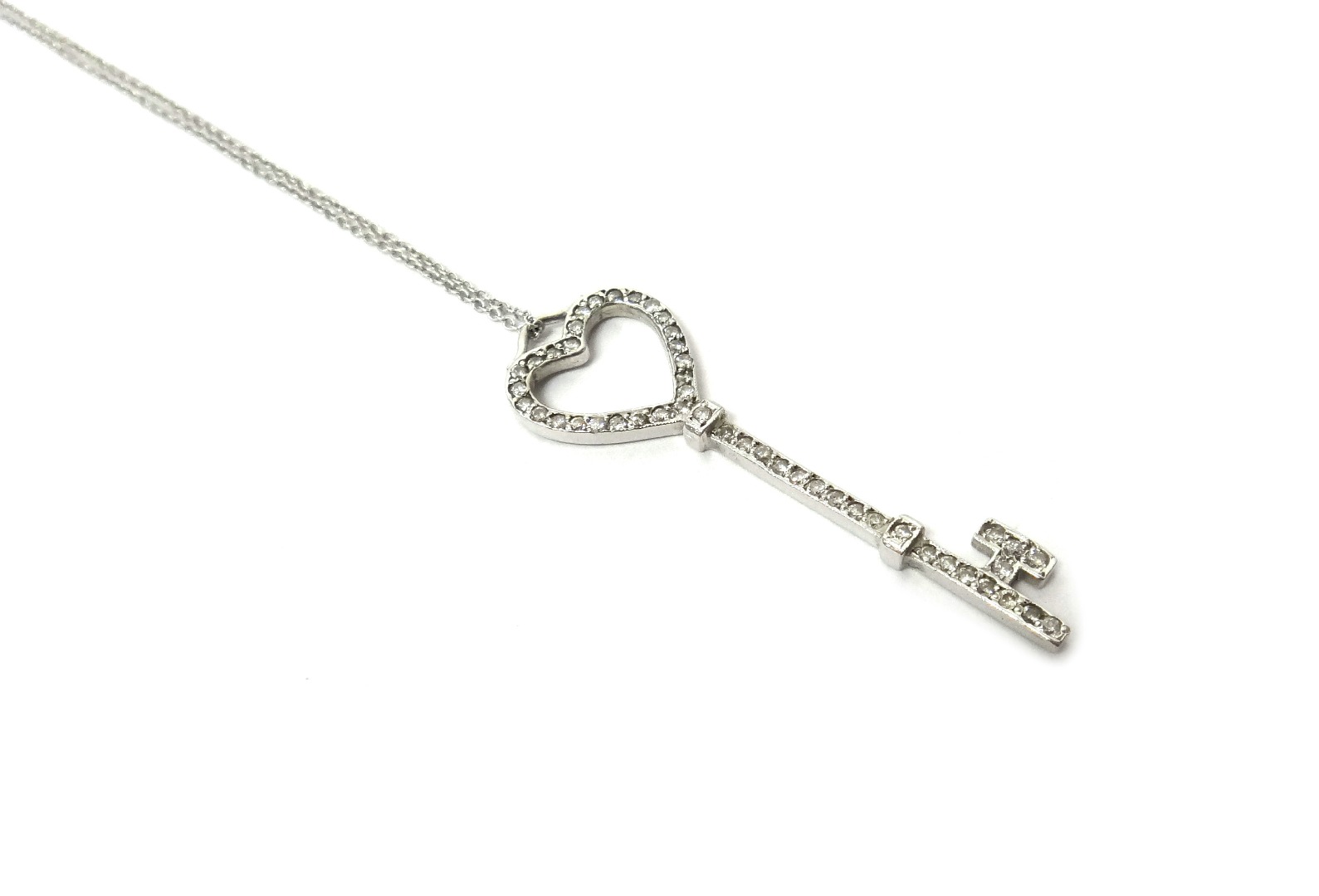 Appraisal: A diamond set pendant designed as a key having a