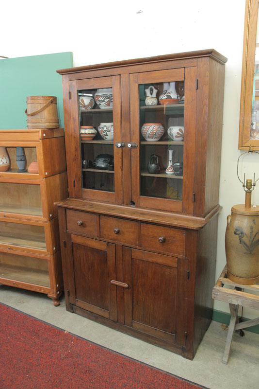 Appraisal: TWO PIECE STEPBACK CUPBOARD Walnut having glazed top doors with