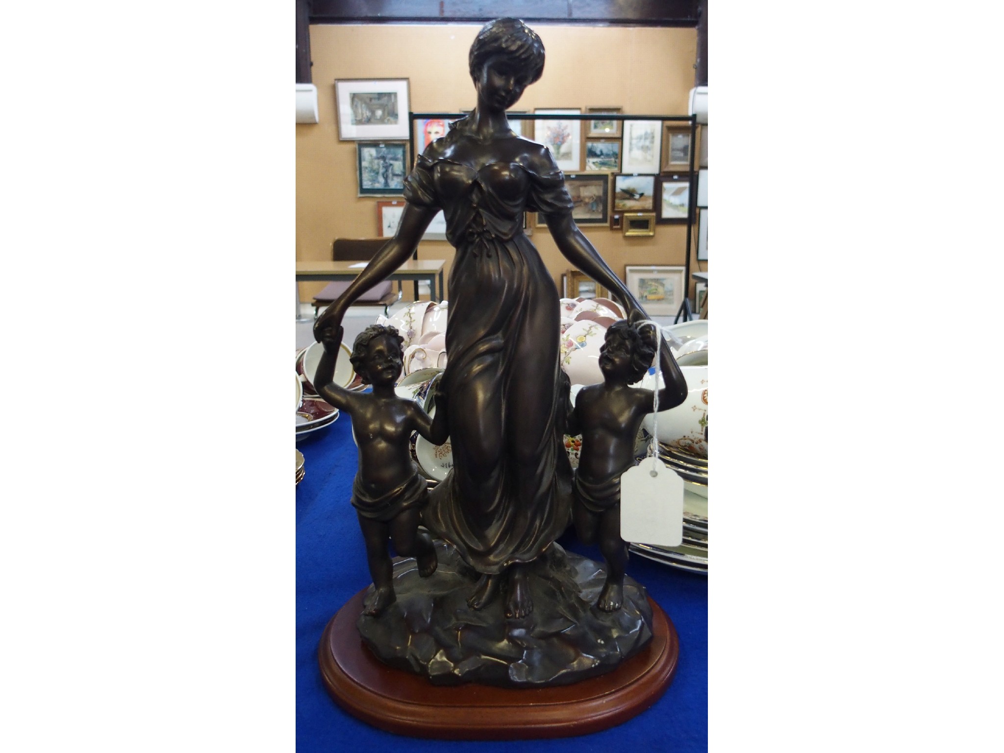 Appraisal: Resin figural group of a draped woman and two children