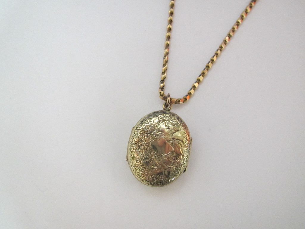 Appraisal: A Victorian gold back and front engraved oval locket with