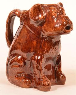 Appraisal: Seated Dog Figural Redware Pottery Pitcher Molded and Mottle Glazed