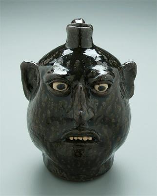 Appraisal: Lanier Meaders stoneware face jug runny dark olive alkaline glaze