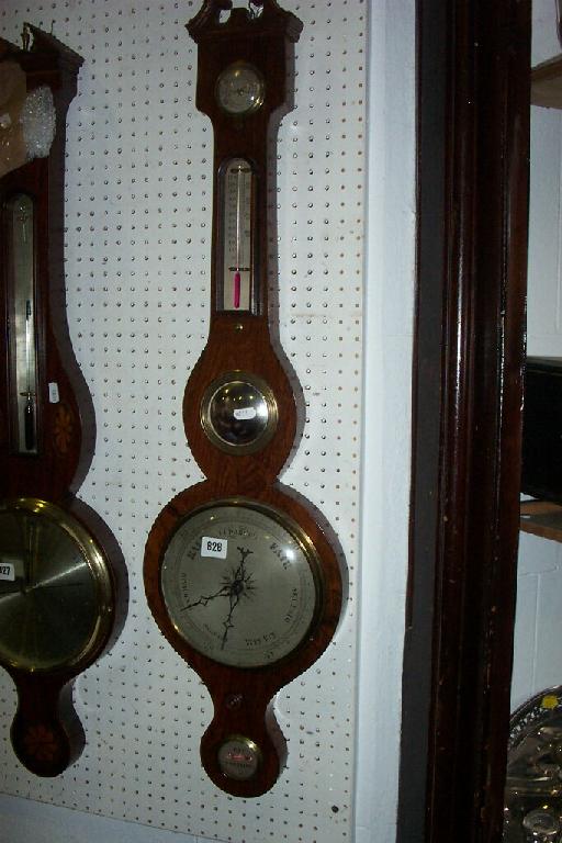 Appraisal: A Victorian wheel barometer with a rosewood veneered case and