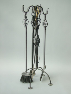 Appraisal: An Arts Crafts style wrought iron four piece set of