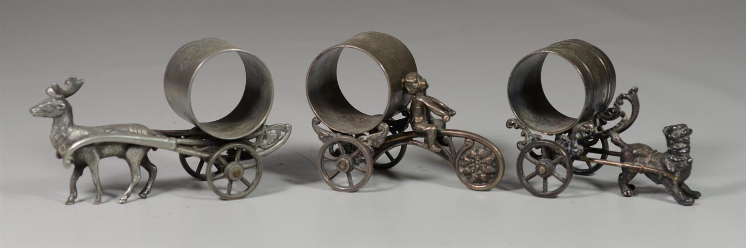 Appraisal: Plated silver napkin rings on carriages one with cherub one