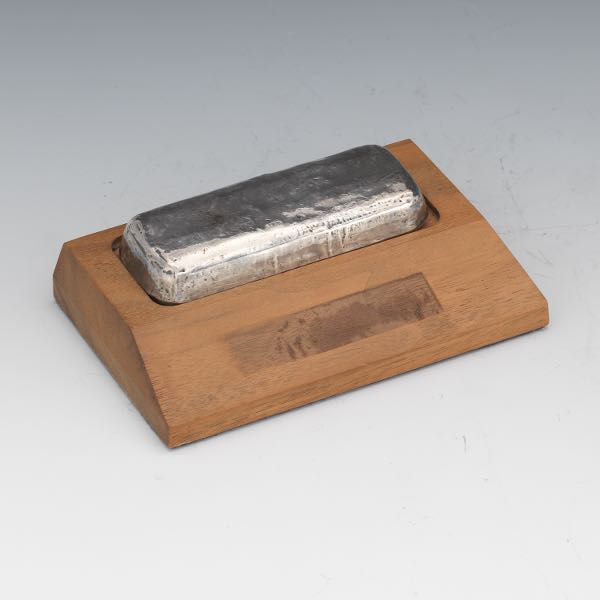 Appraisal: SILVER BRICK x x Silver brick on a small wooden