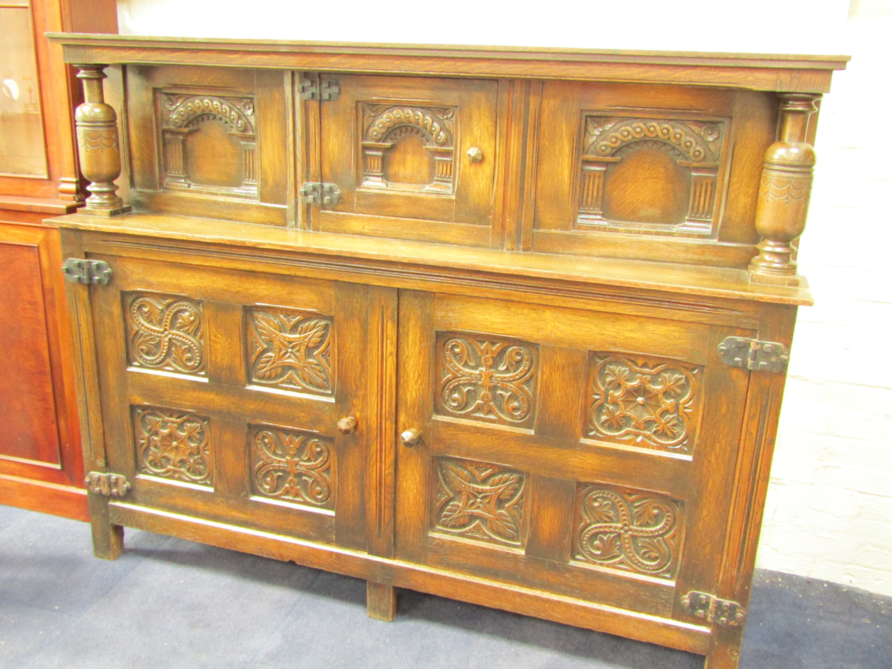 Appraisal: An Elizabethan style oak court cupboard the triple panel top