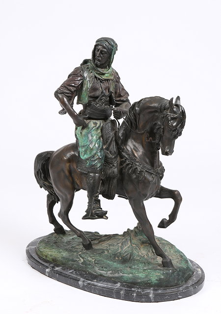 Appraisal: A BRONZE SCULPTURE of an Arab riding on horseback with