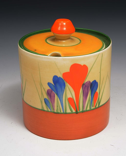 Appraisal: A Clarice Cliff jam pot and coverpainted with spring crocus