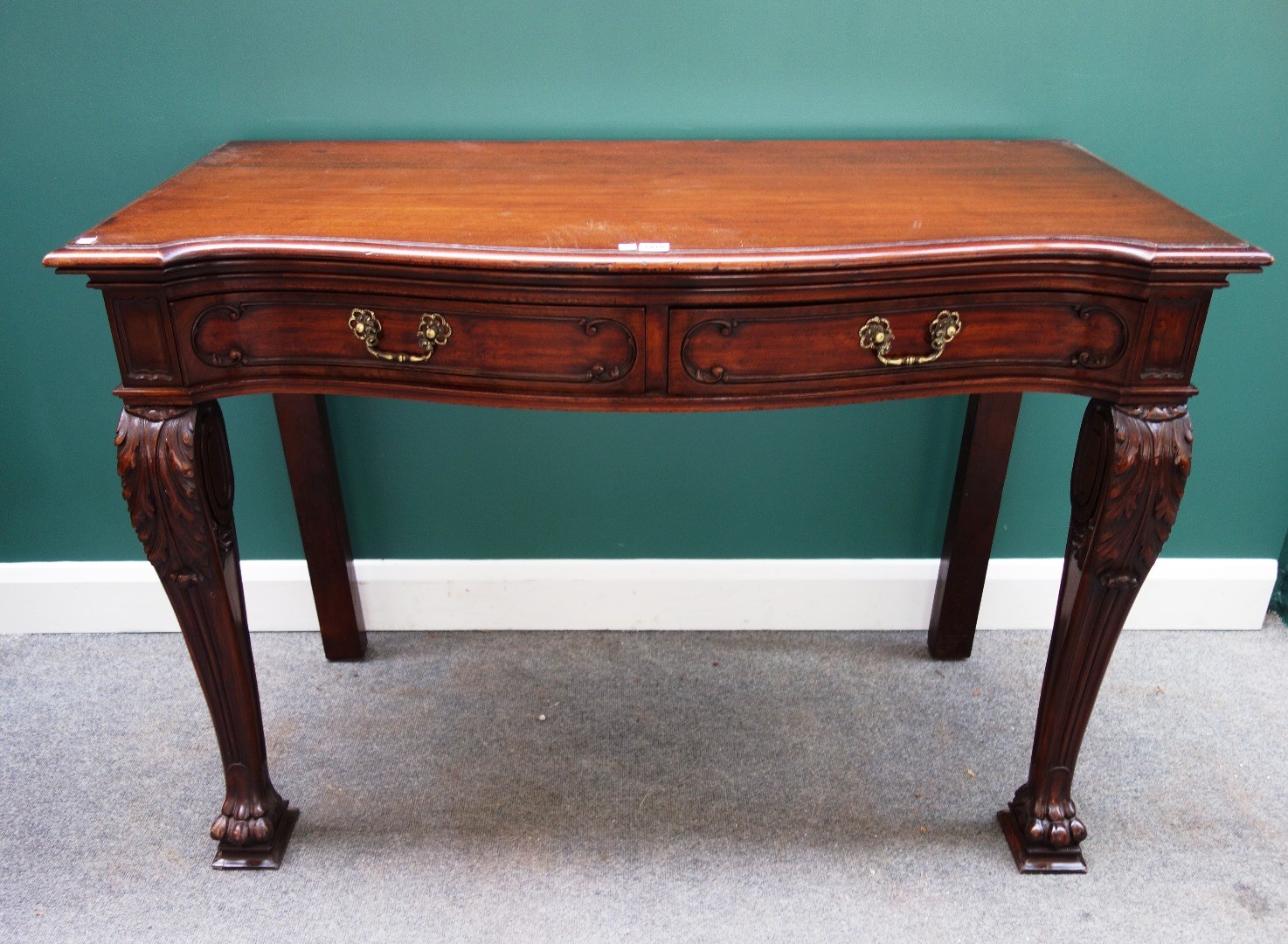 Appraisal: An th century style mahogany serving table the serpentine top