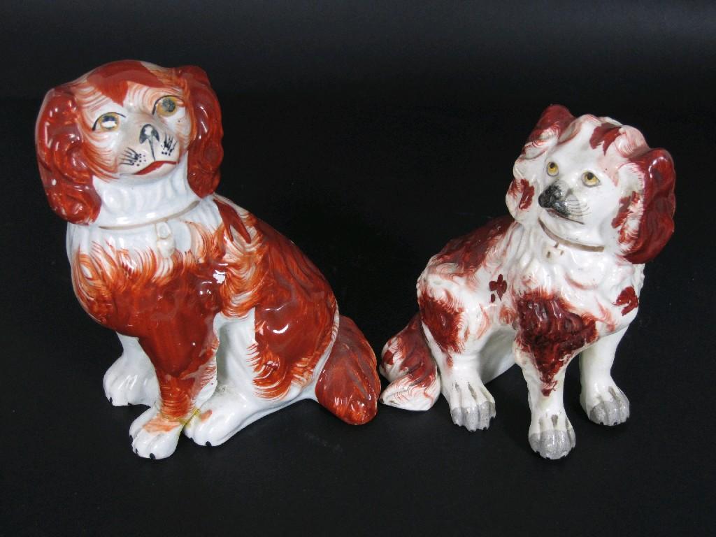 Appraisal: Two Staffordshire seated Spaniels with iron red details in and