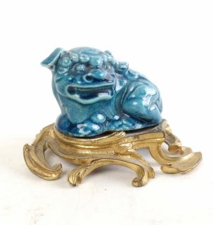 Appraisal: Ceramic Foo Dog on Gilt Base Chinese foo dog on