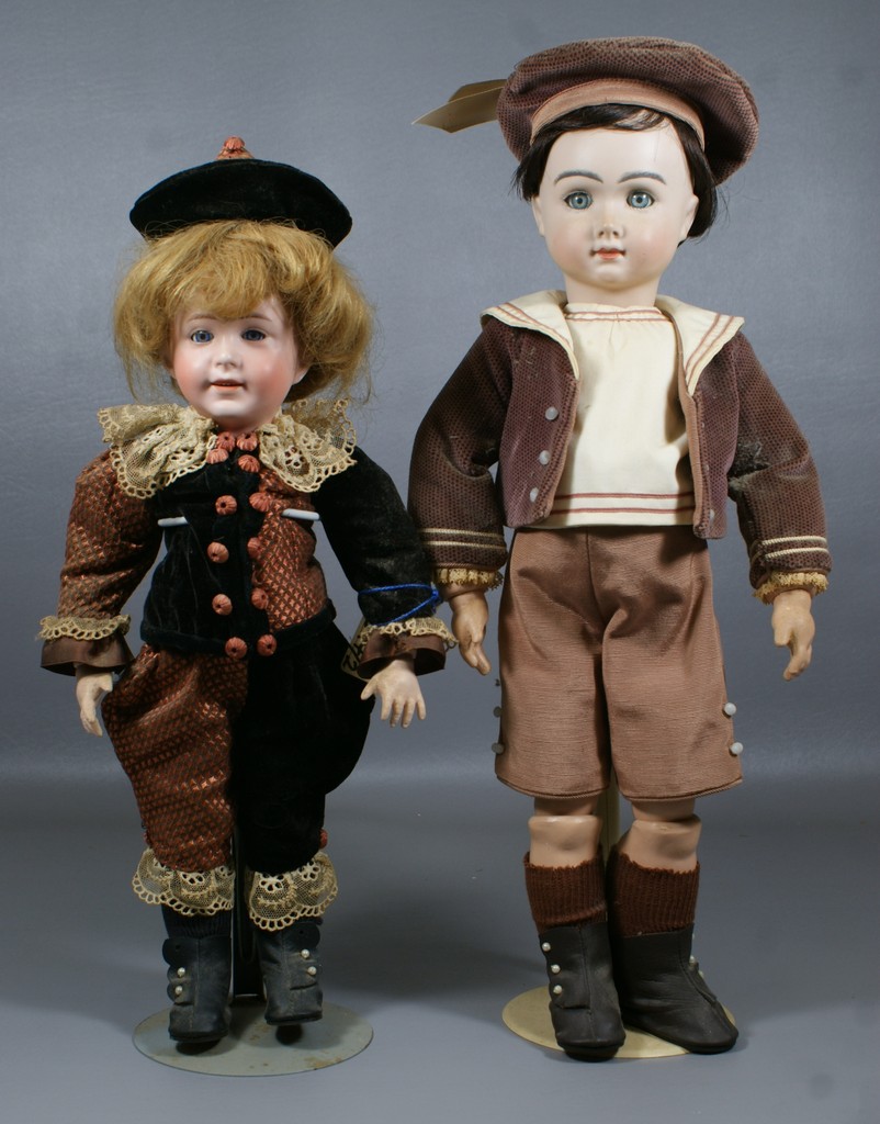 Appraisal: Reproduction French Bisque Boy Dolls larger is a replica of