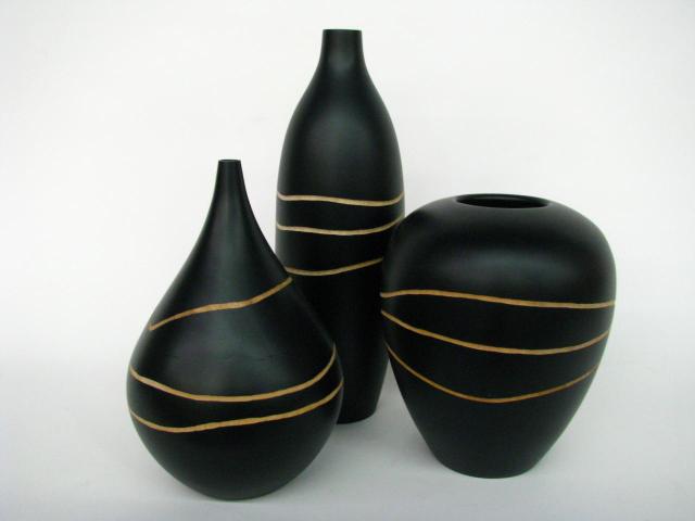 Appraisal: Three decorative black painted wooden gallery vases and inches high