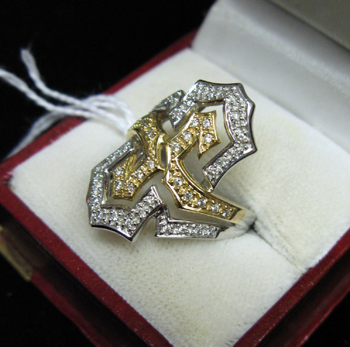 Appraisal: DIAMOND FOURTEEN KARAT YELLOW AND WHITE GOLD RING The pierced