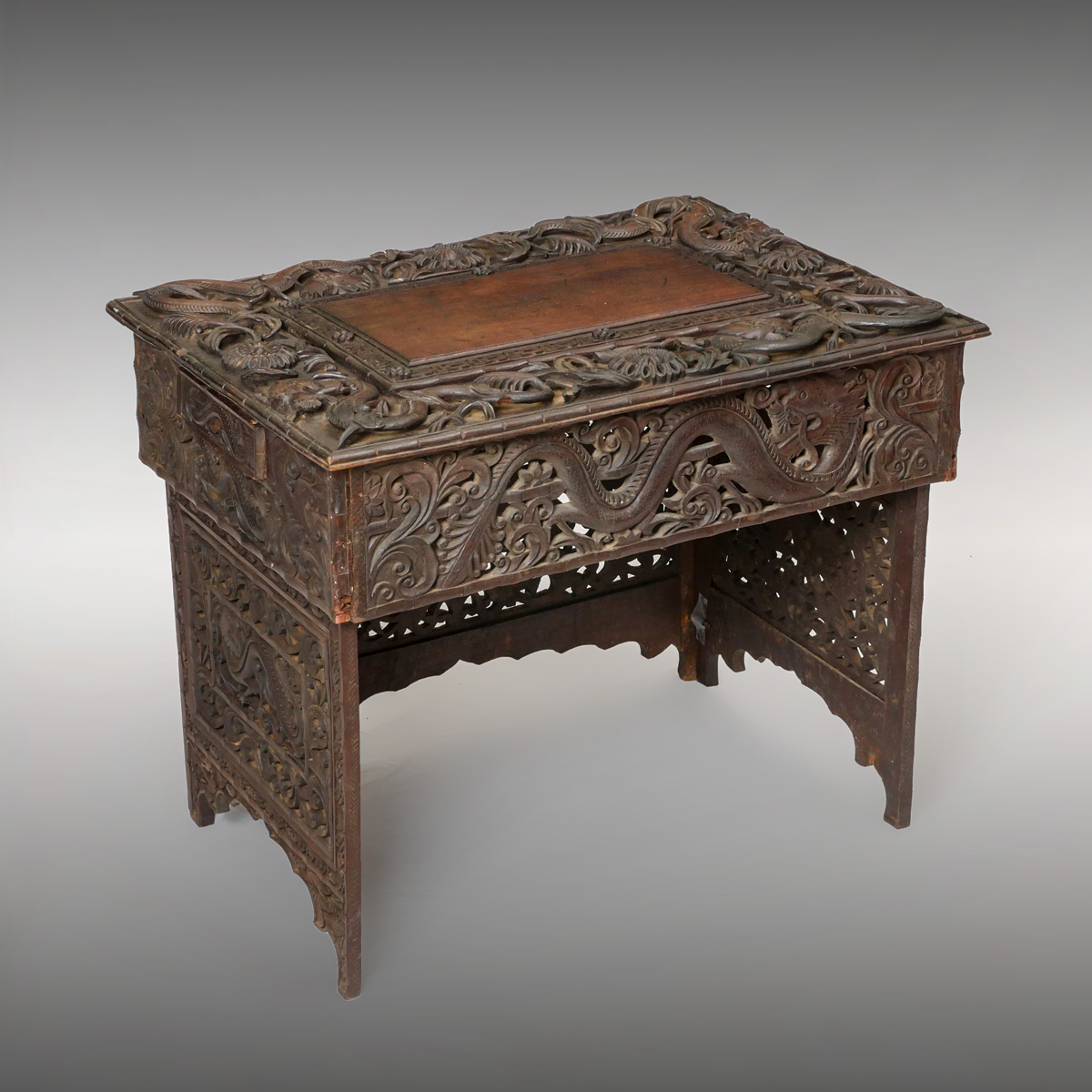 Appraisal: CARVED PIERCED COLLAPSIBLE DRAGON TABLE th century hand-carved middle eastern