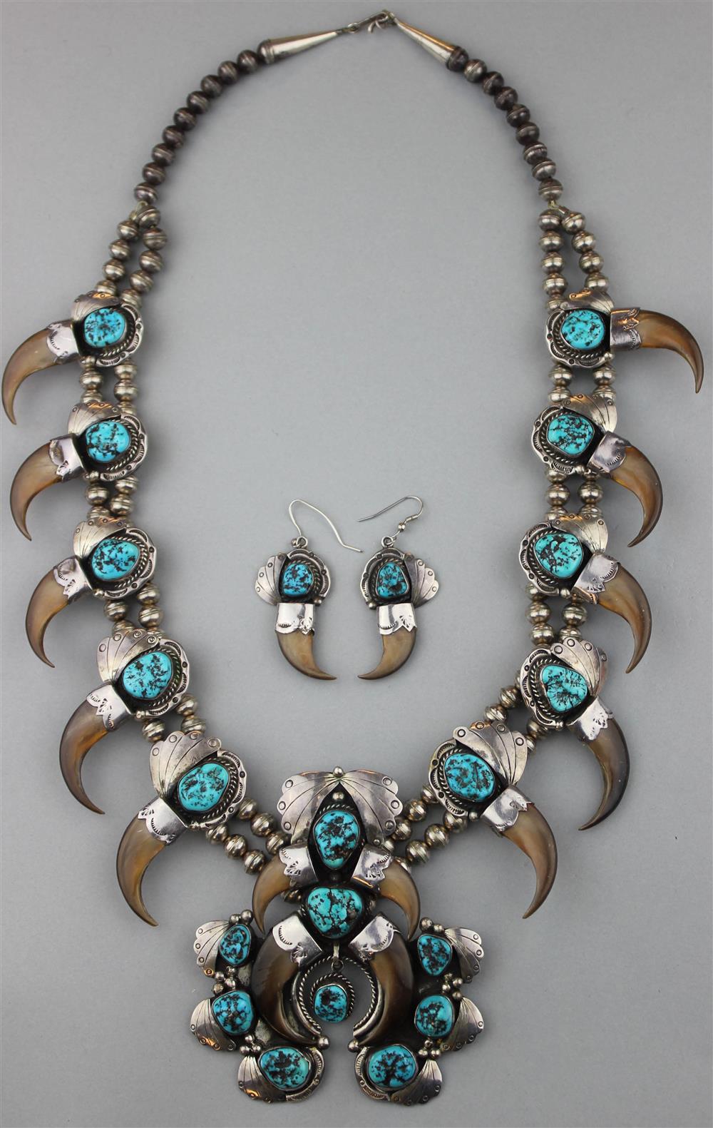 Appraisal: NAVAJO STYLIZED SILVER TURQUOISE AND CLAW NECKLACE strung on silver