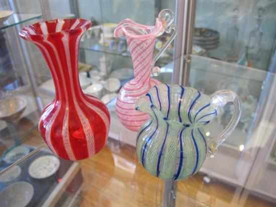 Appraisal: THREE SMALL LATTICINO GLASS JUGS GREEN RED AND PINK