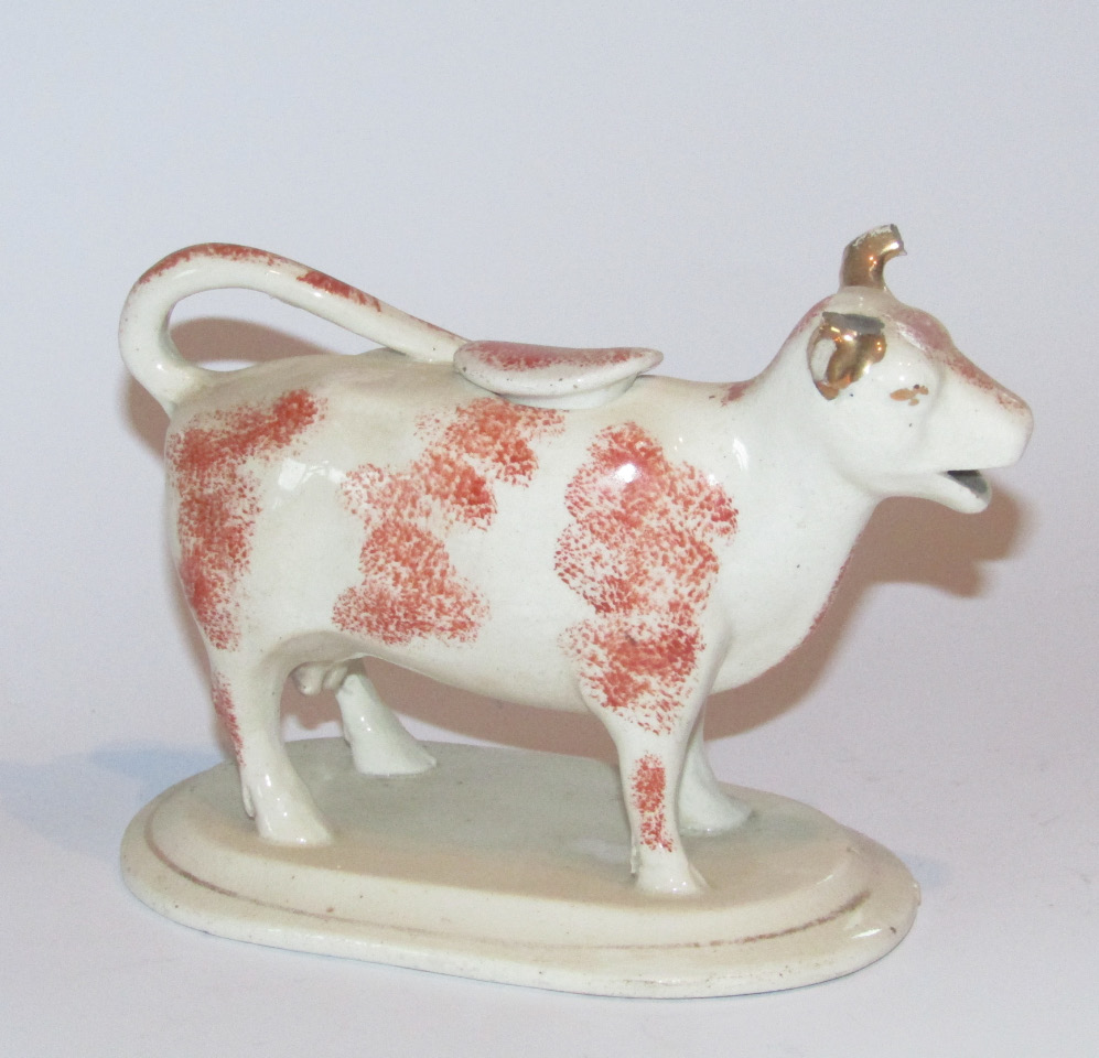 Appraisal: A thC Staffordshire cow creamer with tail handle and stopper