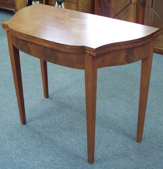 Appraisal: A mahogany serpentine front tea table on square taper legs