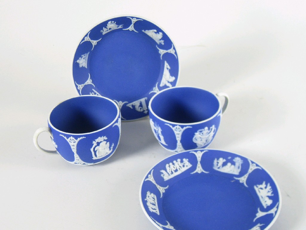 Appraisal: Two Wedgwood blue jasper ware Cups and Saucers with frieze