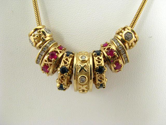 Appraisal: K yellow gold necklace with roundels with sapphires rubies and