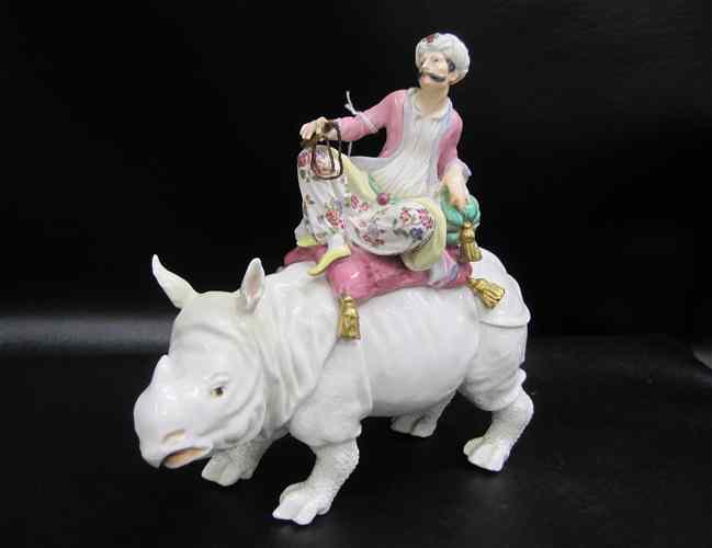 Appraisal: GERMAN PORCELAIN FIGURINE White hand painted hippopotamus with rider wearing