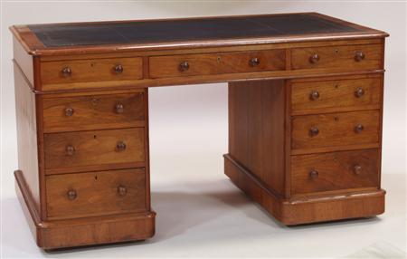 Appraisal: A th century walnut twin pedestal desk the moulded rounded