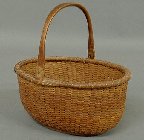 Appraisal: Rare oblong Nantucket basket c with wood base and swing