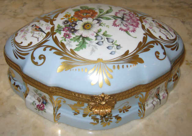 Appraisal: LIMOGES CASTEL PORCELAIN JEWELRY BOX Cartouche form gilt metal mounted