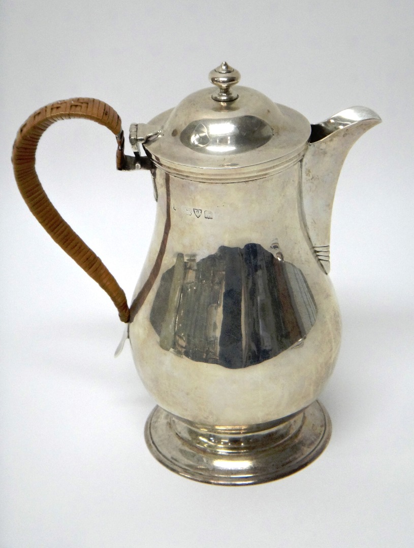 Appraisal: A silver hot water jug of baluster form having a