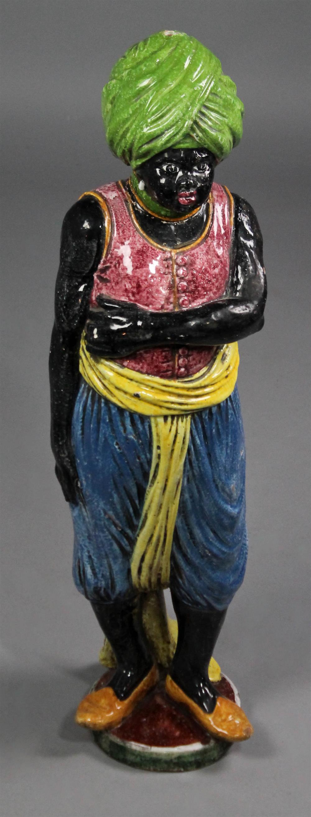 Appraisal: TIN GLAZED FIGURE OF A BLACKAMOOR in green turban red