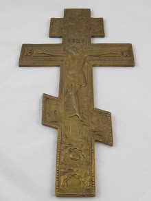 Appraisal: A Russian Orthodox gilded brass crucifix the recessed verso chased