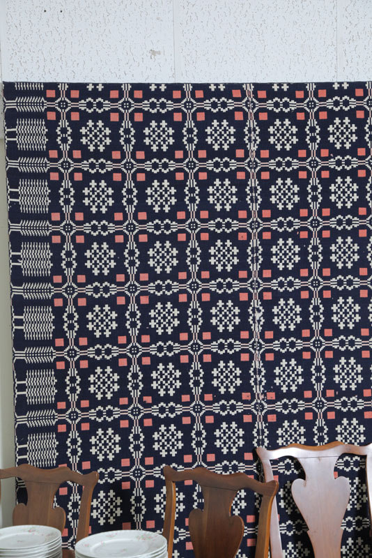 Appraisal: FRAMED COVERLET Red white and blue coverlet with geometric motif