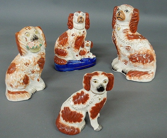 Appraisal: Five assorted Staffordshire seated Spaniels c largest h