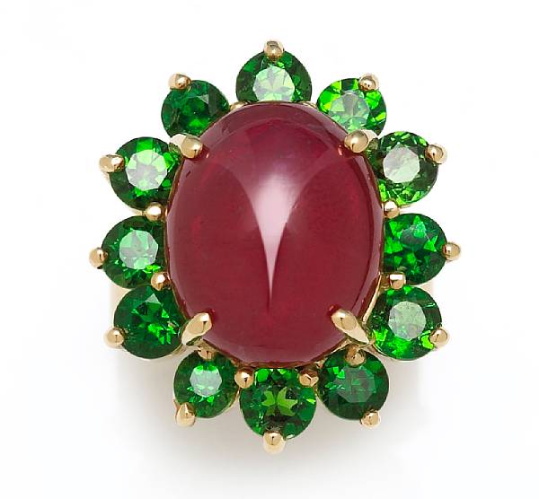 Appraisal: A ruby and tsavorite ring centering an oval-shaped ruby cabochon