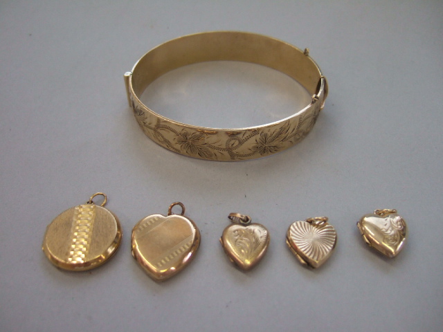 Appraisal: A gold plated oval hinged bangle the front with foliate