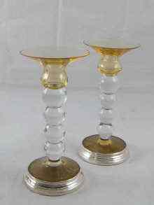 Appraisal: A pair of modern candlesticks the knopped clear glass columns