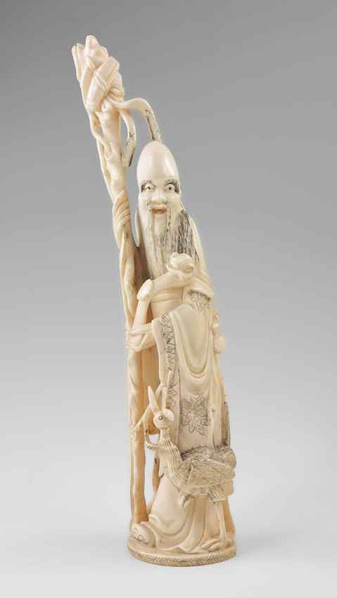 Appraisal: CARVED IVORY ELDER Figure of Elder with crane leaning against