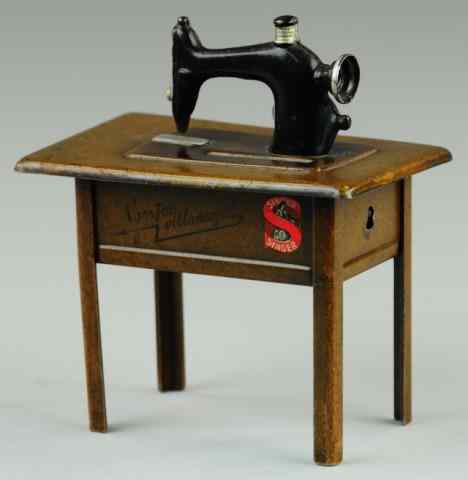 Appraisal: SINGER SEWING MACHINE STILL BANK C Germany covered tin table