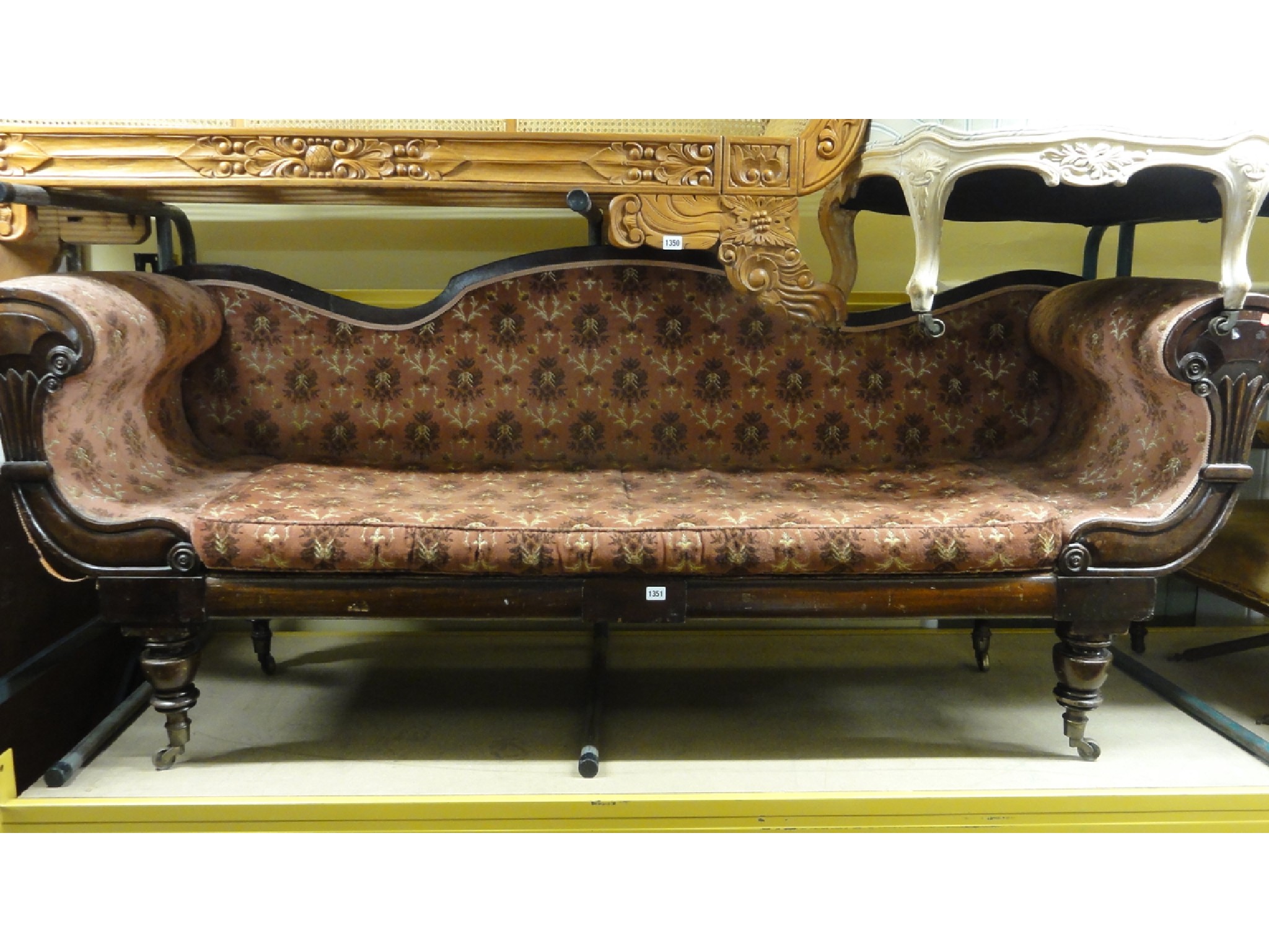 Appraisal: An early th century three seat double scroll arm sofa