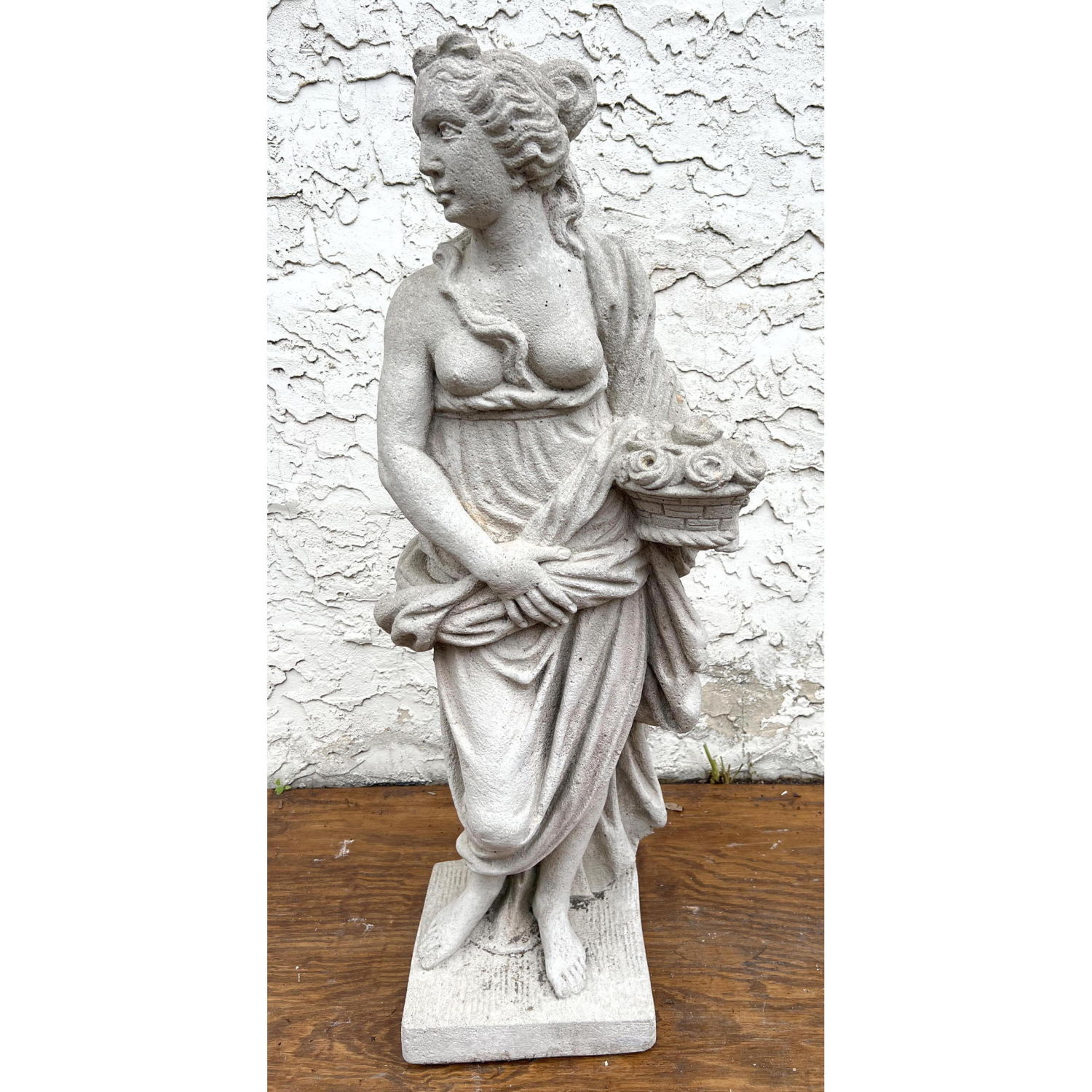 Appraisal: Cast Stone Garden Sculpture Woman with flower basket Dimensions H