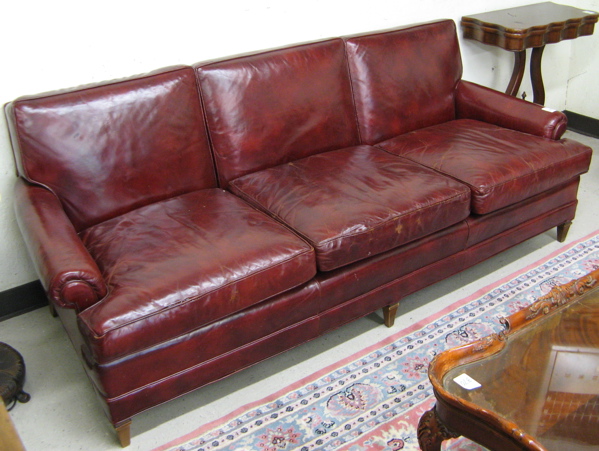 Appraisal: MODERN BURGUNDY LEATHER SOFA America having a three-cushion back and