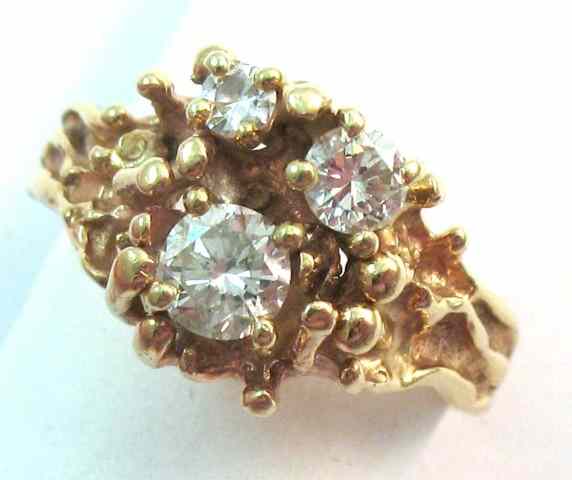 Appraisal: DIAMOND AND FOURTEEN KARAT GOLD RING set with three round-cut