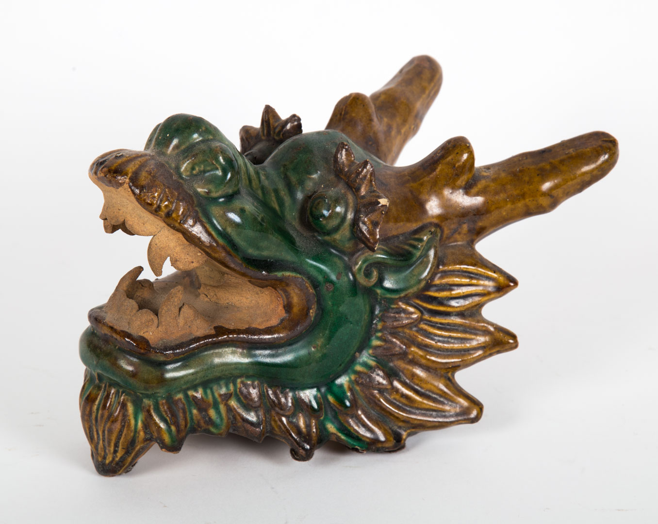 Appraisal: Chinese glazed terracotta dragon head roof tile in H in