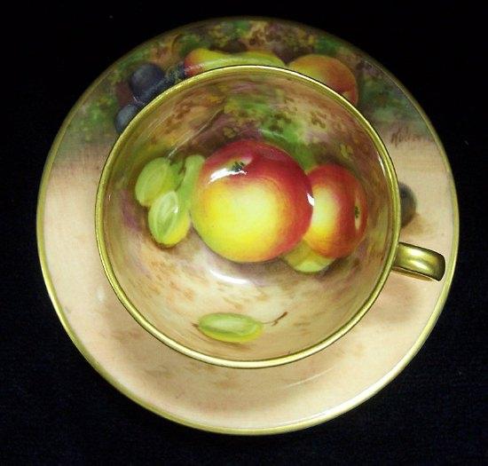 Appraisal: A Royal Worcester miniature cup and saucer decorated pears and